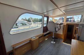 Interior of 2024 Piper 12c boat with helm, seating, and large windows.