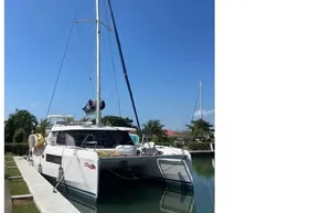 2022 Leopard 45 catamaran docked under clear blue sky.