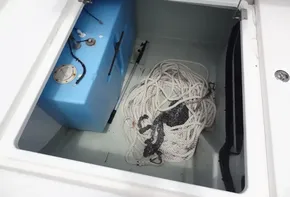 Storage compartment of a 2020 Leopard 43 Powercat with ropes and a blue tank.