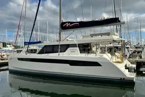 Luxury Leopard 50 catamaran yacht docked in marina, 2021 model, under cloudy sky.