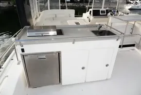 Outdoor kitchen area on a 2018 Leopard 43 Powercat yacht with sink and grill.