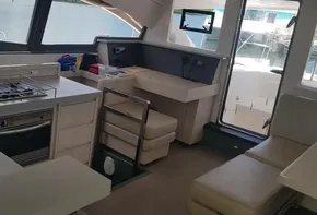 Modern kitchen and dining area inside a 2017 Leopard 48 catamaran yacht.