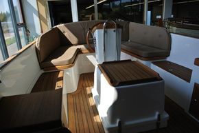 Interior of 2026 Enkhuizensloep 615 boat with wooden flooring and cushioned seating.