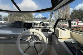 Cockpit view of a 1991 Sealine 290 Ambassador boat with steering wheel and controls.