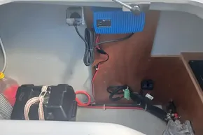 Electrical setup in a 2024 Lagoon 42 boat, featuring a battery and charger.