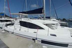 2017 Leopard 48 catamaran docked at marina under clear blue sky.
