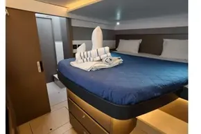 Luxurious cabin interior of 2021 Leopard 50 yacht with cozy bedding and modern design.