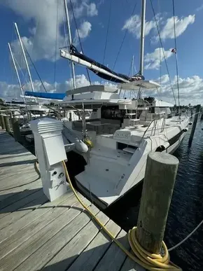 2020 Leopard 50 catamaran docked at marina under blue sky.
