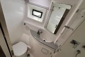 Modern bathroom in 2019 Leopard 51 Powercat yacht with toilet, sink, and mirror.