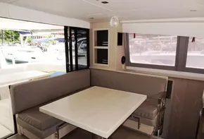 Interior dining area of 2020 Leopard 43 Powercat yacht with modern seating and table.