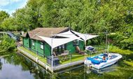 Floating lodge  houseboat on river Great Ouse