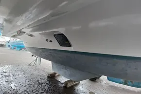 2024 Lagoon 42 catamaran hull on dry dock, showcasing sleek design and structure.