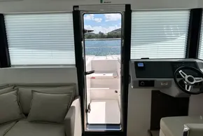 Interior view of 2025 Robertson and Caine Leopard 46 Powercat, featuring helm and seating area.