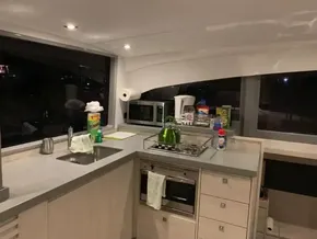 Modern kitchen in a 2020 Leopard 40 catamaran with appliances and a large window.