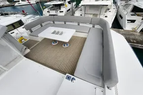 Luxurious 2019 Leopard 50 yacht deck with seating and table, docked at marina.