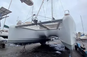 2024 Lagoon 42 catamaran on dry dock, showcasing sleek hull design and modern features.