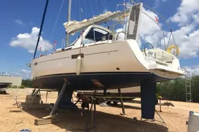 2013 Beneteau Oceanis 41 sailboat on dry dock under maintenance, clear sky background.