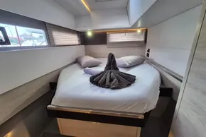 Luxurious cabin interior of 2020 Leopard 45 yacht with neatly arranged bed and towels.