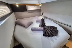 Luxurious cabin interior of 2020 Leopard 45 yacht with neatly arranged bed and towels.