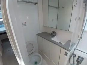 Compact bathroom in 2019 Leopard 45 yacht with toilet, sink, and mirror.