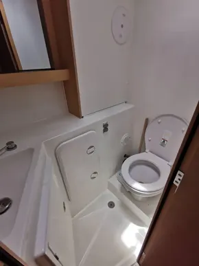 2020 Lagoon 42 yacht bathroom with compact toilet and shower area.