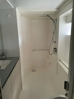 Modern bathroom with sleek shower and vanity in a 2020 Leopard 50 model.