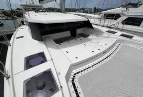 2019 Leopard 45 catamaran docked at marina, featuring spacious deck and netted trampoline.
