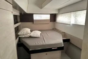 Modern bedroom interior in 2021 Leopard 50 yacht, featuring a cozy bed and soft lighting.