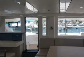 Interior of 2017 Leopard 48 yacht with marina view through windows.