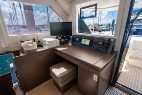Interior of a 2022 Leopard 50 yacht with navigation station and marina view.