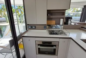 Modern kitchen interior of 2024 Leopard 40 Powercat yacht with stove and oven.