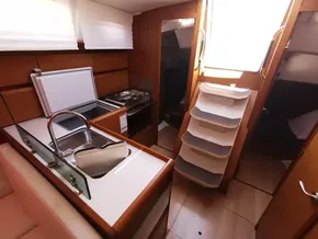 Interior of 2019 Jeanneau Sun Odyssey 389 yacht, featuring kitchen and stairs.