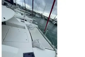 2020 Leopard 40 catamaran deck view at marina, showcasing sleek design and moored boats.