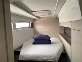 Cozy bedroom interior on a 2020 Leopard 50 yacht with modern design and natural light.
