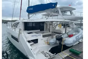 2020 Leopard 40 catamaran docked, featuring a dinghy and Sunsail branding.