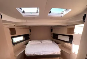 Interior of 2020 Beneteau Oceanis 46.1 yacht with cozy double bed and skylights.