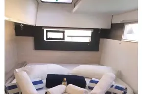 Luxurious cabin interior of 2020 Leopard 40 yacht with neatly arranged towels and bedding.