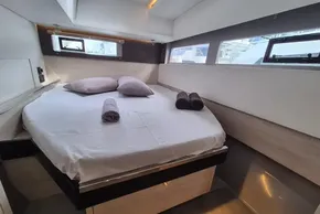 Luxurious cabin interior of 2020 Leopard 45 yacht with neatly arranged bed and towels.