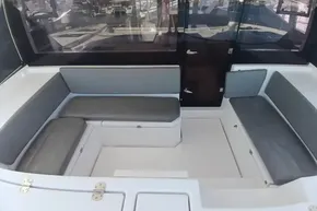 Interior seating area of a 2022 Leopard 45 catamaran with gray cushions.