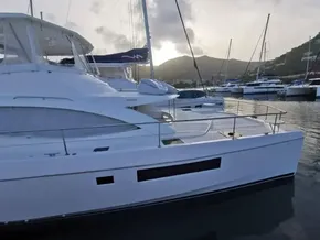 2017 Leopard 51 Powercat yacht docked at a marina with mountains in the background.
