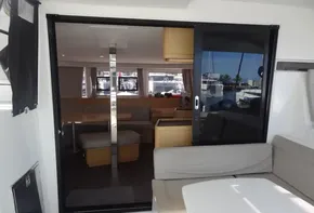 Interior view of 2020 Lagoon 42 catamaran with modern seating and large windows.