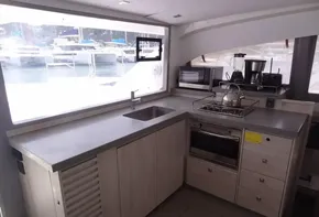 Modern kitchen in a 2020 Leopard 43 Powercat yacht with appliances and marina view.