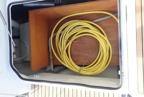 Storage compartment with yellow hose on Jeanneau Sun Odyssey 440, 2019 model.