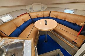 Interior of 1998 Maxum 2400 SCR boat with cozy seating and table.
