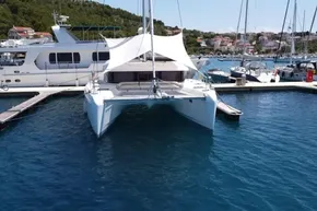 2024 Lagoon 42 catamaran docked in a marina, surrounded by other boats.