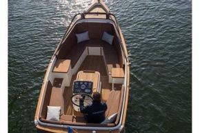 2026 Enkhuizensloep 680 Tender boat on water, featuring elegant wooden deck design.