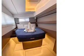 Luxurious cabin interior of 2021 Leopard 50 yacht with elegant bedding and ambient lighting.