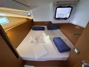 Cozy cabin interior of 2019 Jeanneau Sun Odyssey 440 yacht with neatly arranged bedding.