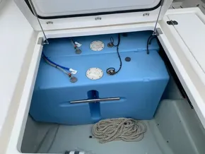 Storage compartment with blue tank and ropes on a 2021 Leopard 45 boat.