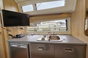 Modern kitchen area in 2023 Balt 818 Titanium boat with sink, stove, and TV.